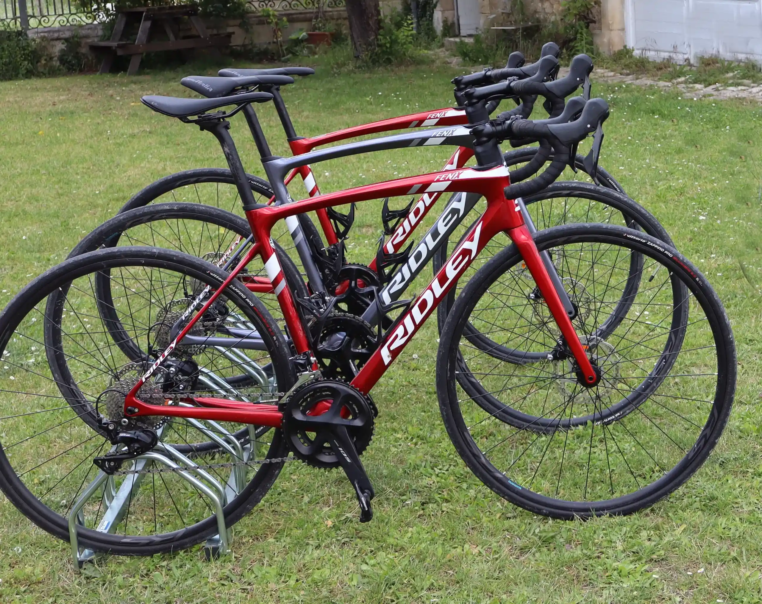 Three Ridley Road bikes on a stand in the garden of The Painted House Gites